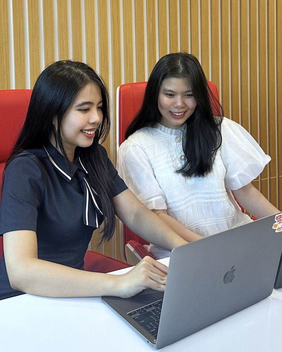 Two members talking over a screen